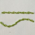 Barb stitch front side - embroidery in blue and yellow thread on white fabric Barred Chain Stitch Small image